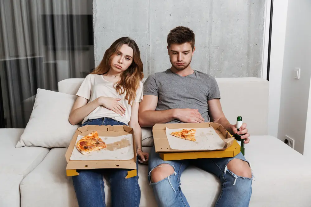 couple enjoying a delicious pizza together